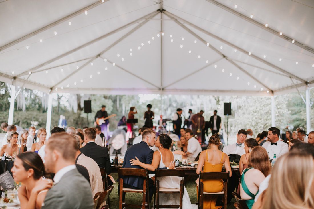 Candid moment between the newlyweds during their Charleston wedding reception