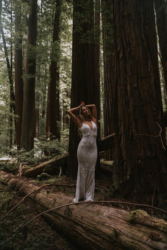 Bride walking a quiet trail through Redwood National Forest in her wedding dress