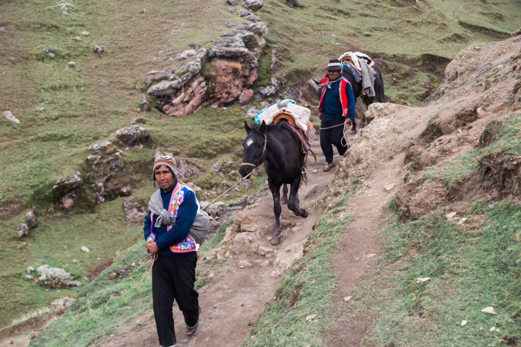 Hikers reaching the summit viewpoint of Rainbow Mountain, Peru