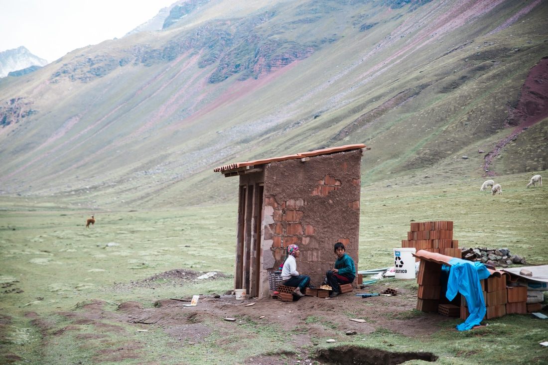 Andean village and grazing livestock along the trail to Vinicunca, Peru