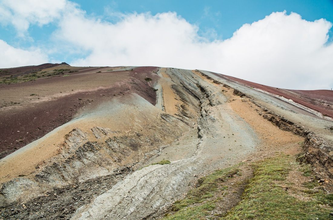 Close-up of the red, gold, and green mineral bands on Rainbow Mountain