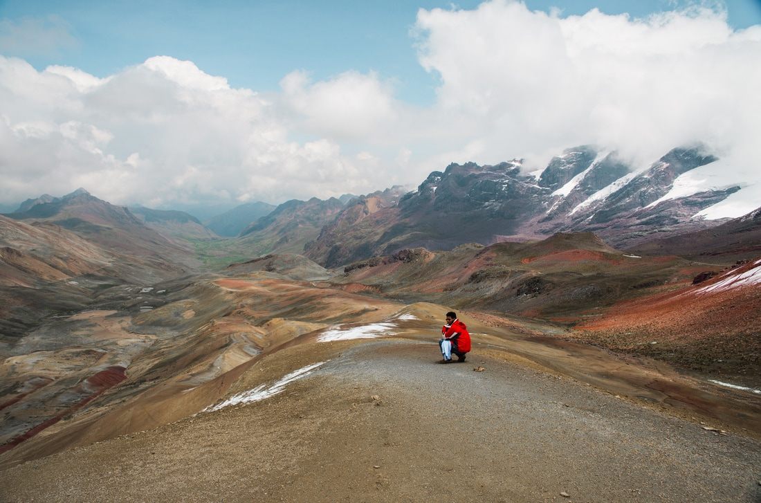 Hikers walking the trail toward Rainbow Mountain in the Cusco region of Peru