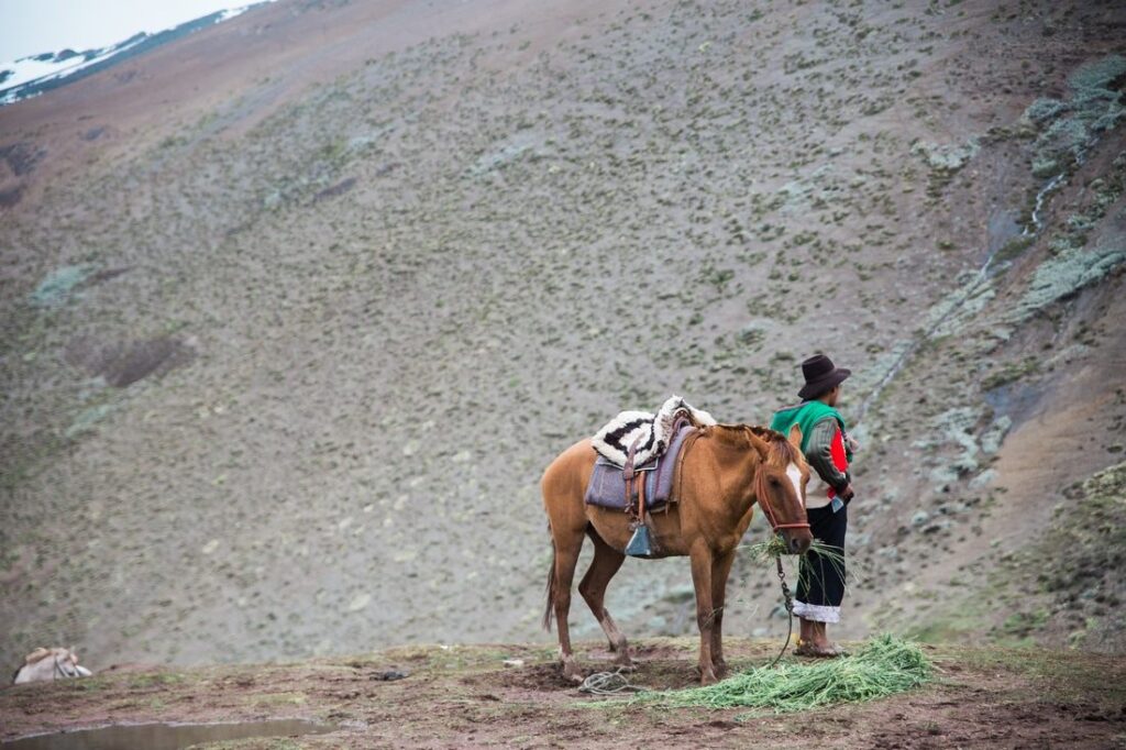 Hikers walking the trail toward Rainbow Mountain in the Cusco region of Peru