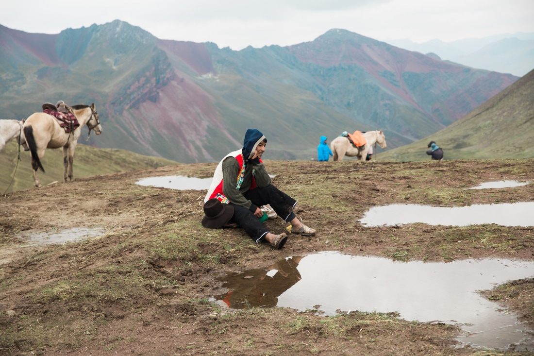 Rugged mountain trail with snow-capped peaks near Vinicunca, Peru