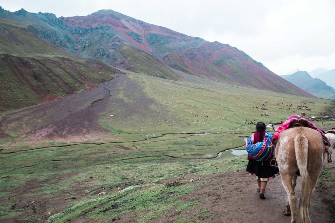 Hikers reaching the summit viewpoint of Rainbow Mountain, Peru