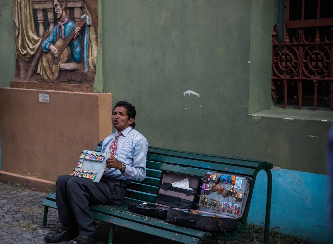 Photo of a street performer drawing a small crowd in Buenos Aires, Argentina