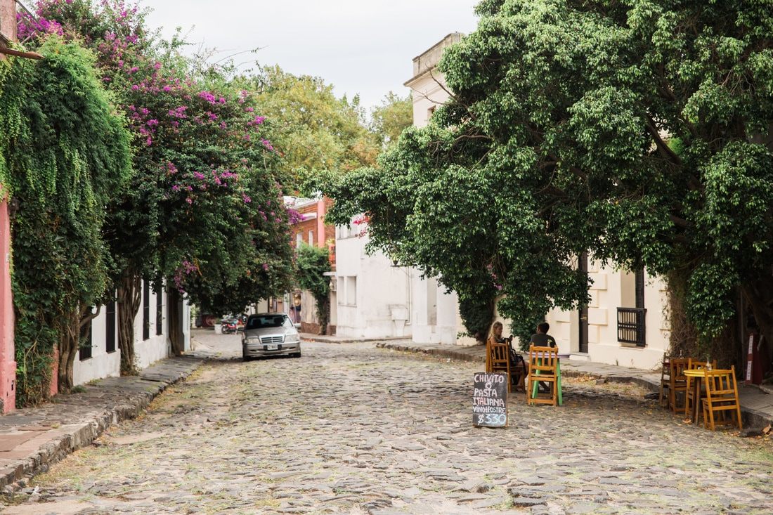 Pastel-colored buildings lining a street in Colonia, Uruguay