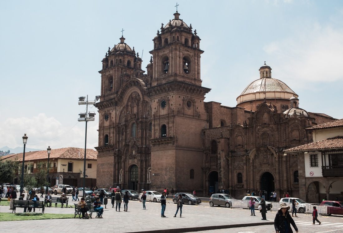 Photo of colorful textiles and market stalls in Cusco, Peru