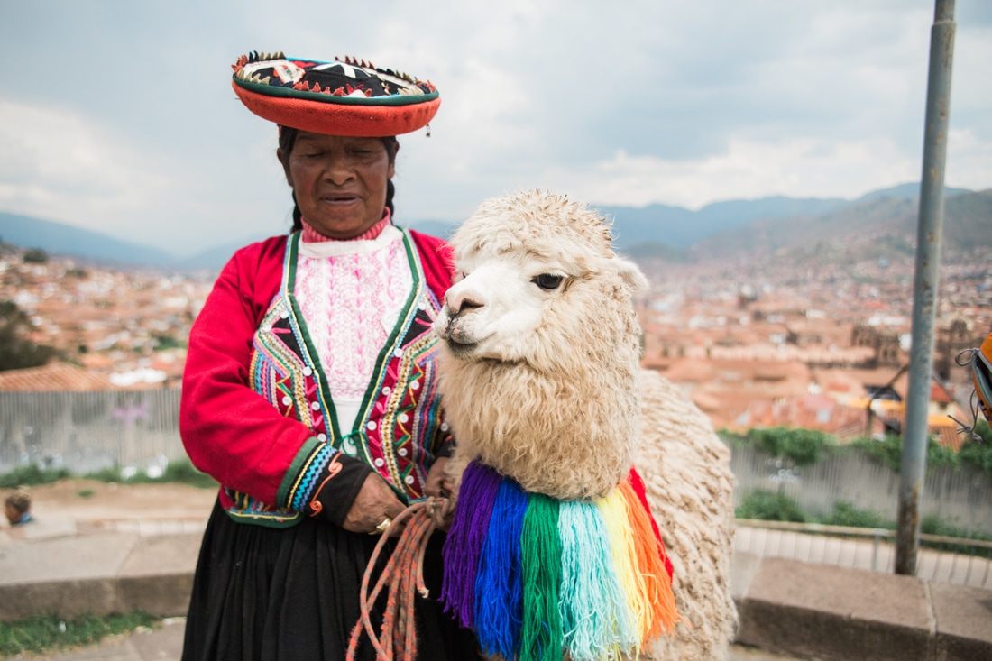 Photo of local life in a city plaza high in the Andes in Cusco, Peru