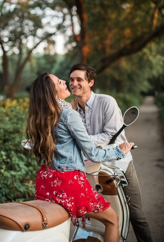 Couple popping a bottle of champagne during their portrait session
