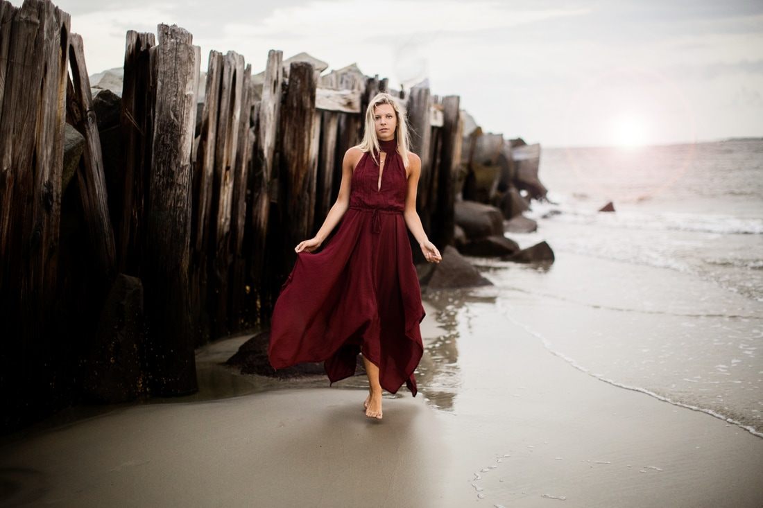 Audrey Smoak walking along the shoreline at Sullivan's Island during golden hour