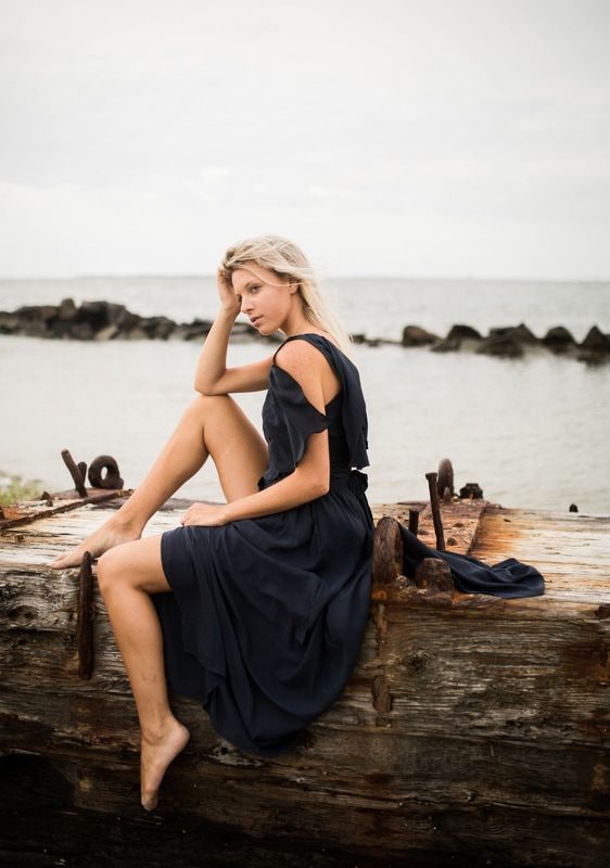Silhouette-style portrait of Audrey Smoak against the sunset at Sullivan's Island