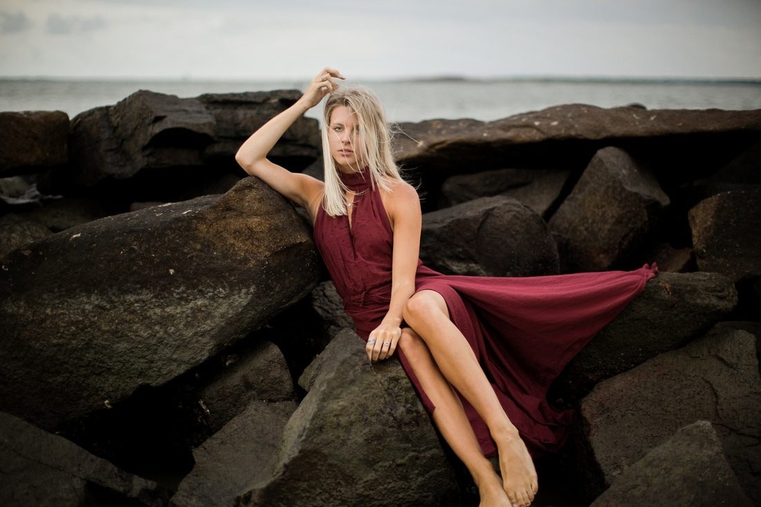 Audrey Smoak styled portrait with ocean waves rolling in behind her