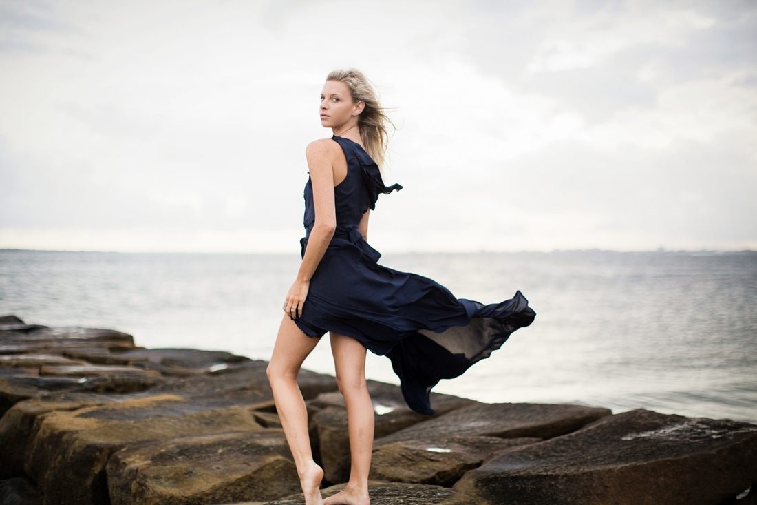 Silhouette-style portrait of Audrey Smoak against the sunset at Sullivan's Island, another frame from the session