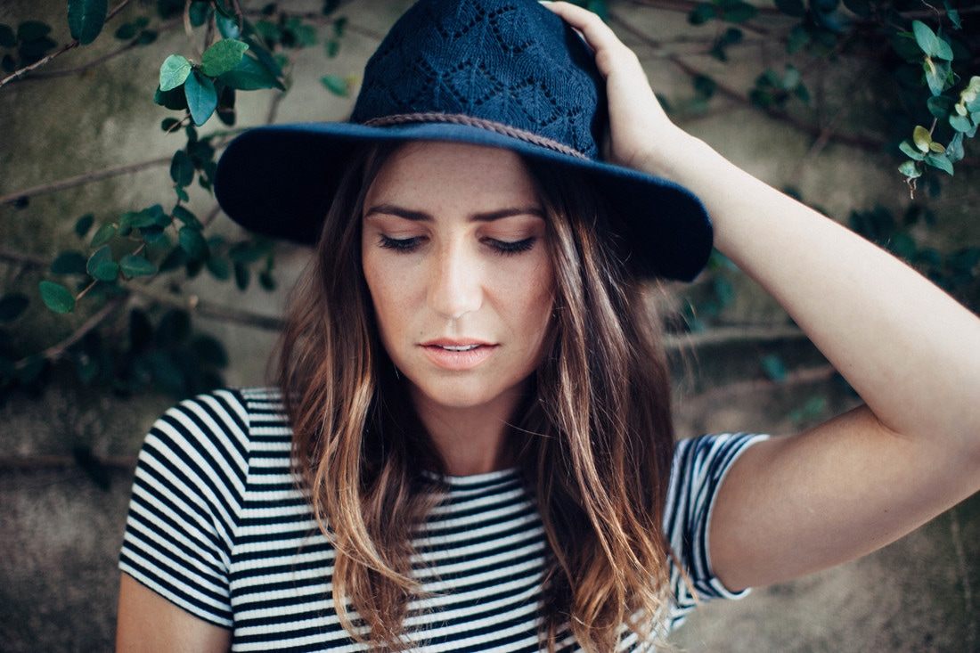 Susan posing near ivy-covered brick walls in downtown Charleston