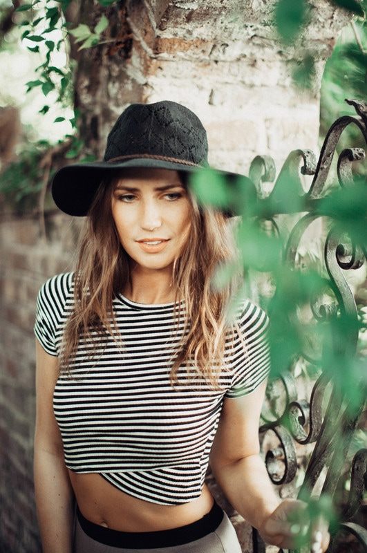 Portrait of Susan wearing a black hat during a Charleston alley photo session