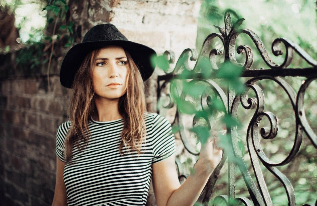 Susan strolling a historic Charleston alleyway during her portrait session