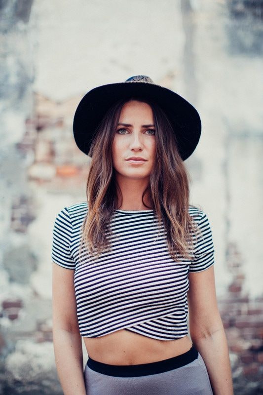 Susan posing near ivy-covered brick walls in downtown Charleston