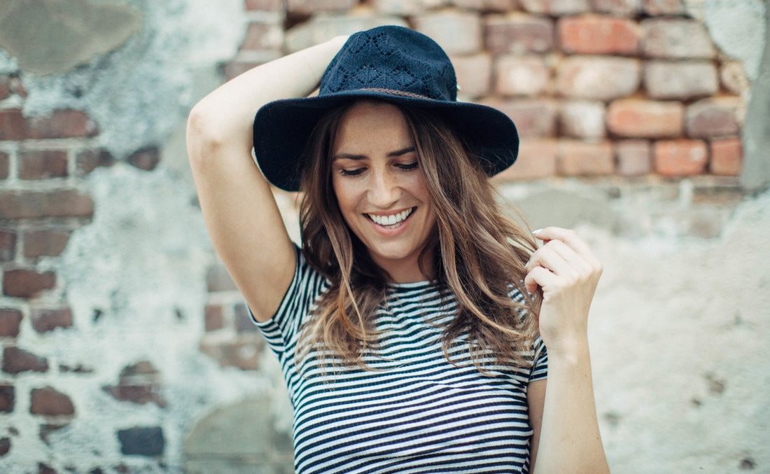 Portrait of Susan wearing a black hat during a Charleston alley photo session