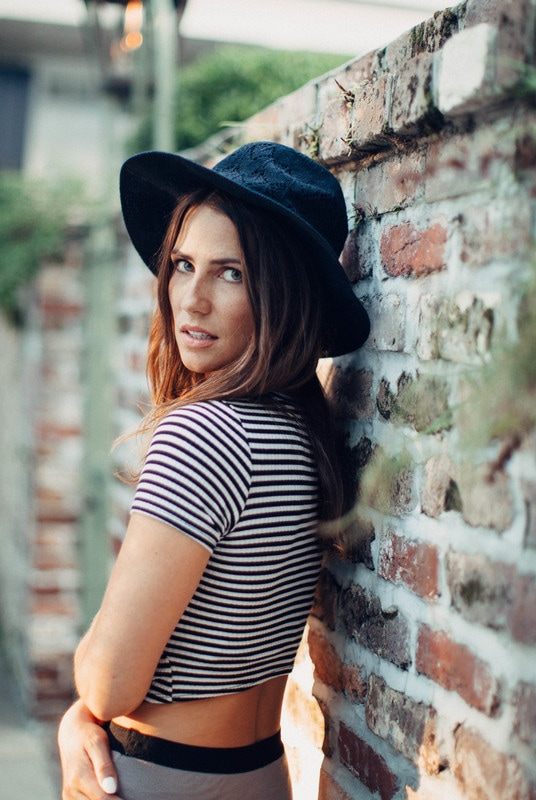 Portrait of Susan wearing a black hat during a Charleston alley photo session
