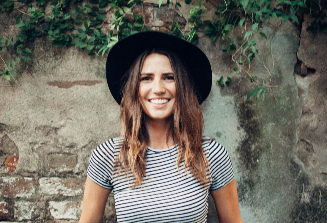 Susan posing near ivy-covered brick walls in downtown Charleston