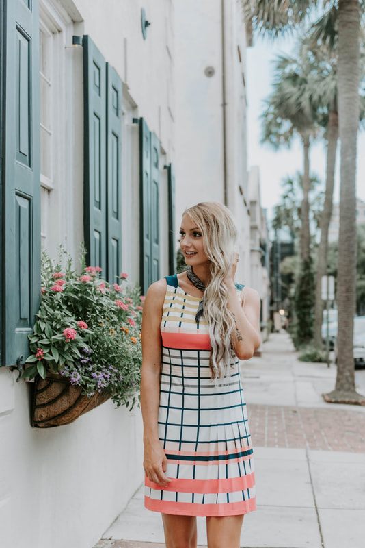 Close-up portrait of Lindsey O with soft natural light on a Charleston side street