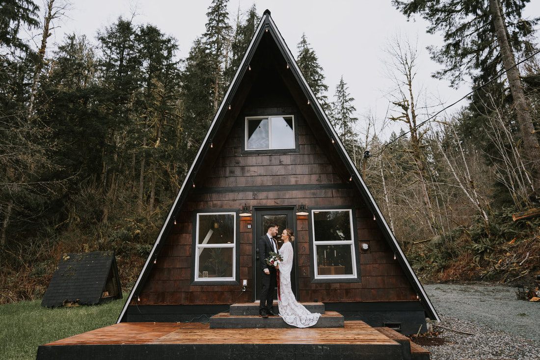 Tanya and Drew sharing a close embrace outside That PNW Cabin.