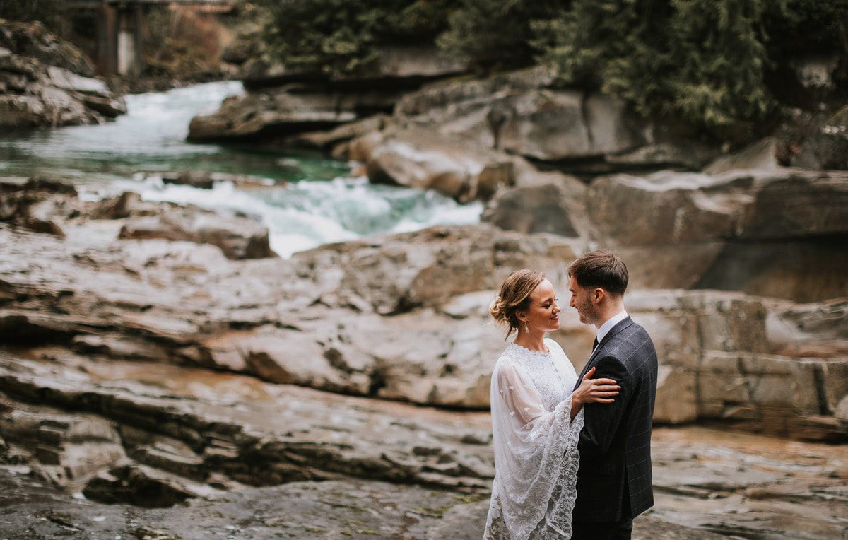 Tanya and Drew sharing a close embrace outside That PNW Cabin.