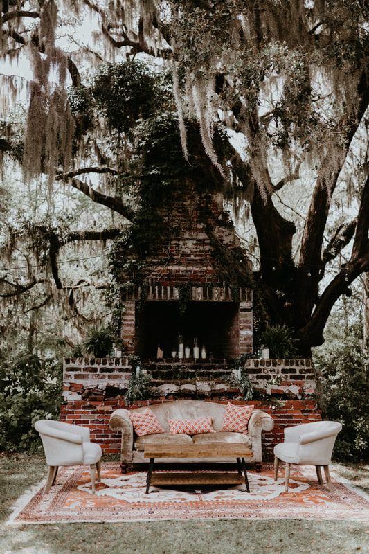 The bride and groom celebrating with friends and family surrounded by garden greenery