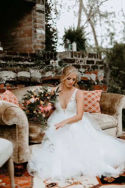 Alexis and Max celebrating with friends and family amid vintage furniture and lush florals