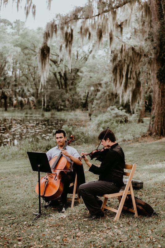 Alexis and Max dancing during the reception surrounded by garden greenery