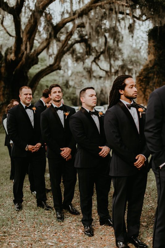 Max posing for portraits in front of the Johns Island barn venue