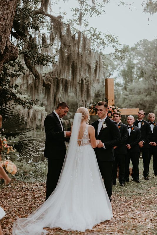 The newlyweds celebrating with friends and family near the reception pond