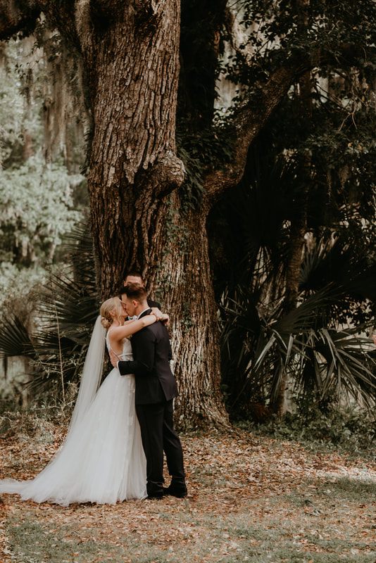 The bride and groom sharing a quiet moment amid vintage furniture and lush florals