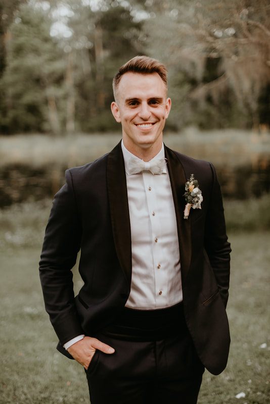 The newlyweds dancing during the reception amid vintage furniture and lush florals
