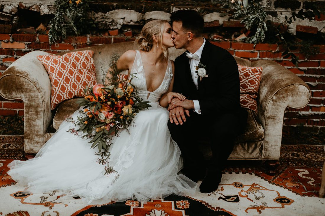 Alexis walking hand in hand amid vintage furniture and lush florals