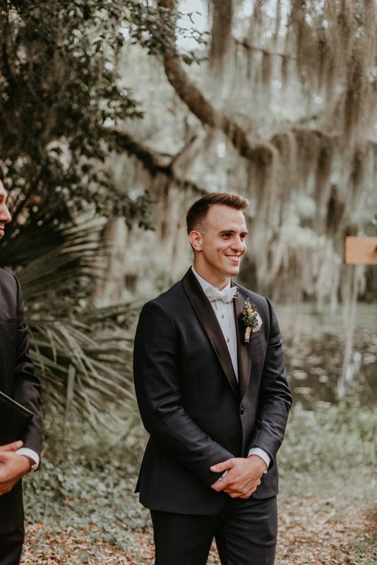 The bride and groom walking hand in hand at their Charleston-area wedding celebration