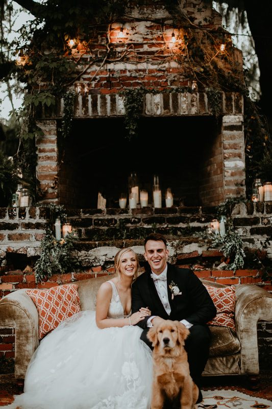 The newlyweds laughing together in front of the Johns Island barn venue