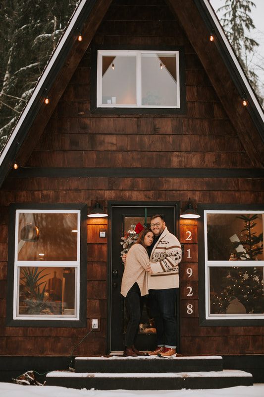 Candid moment between the couple and their dogs on the cabin porch