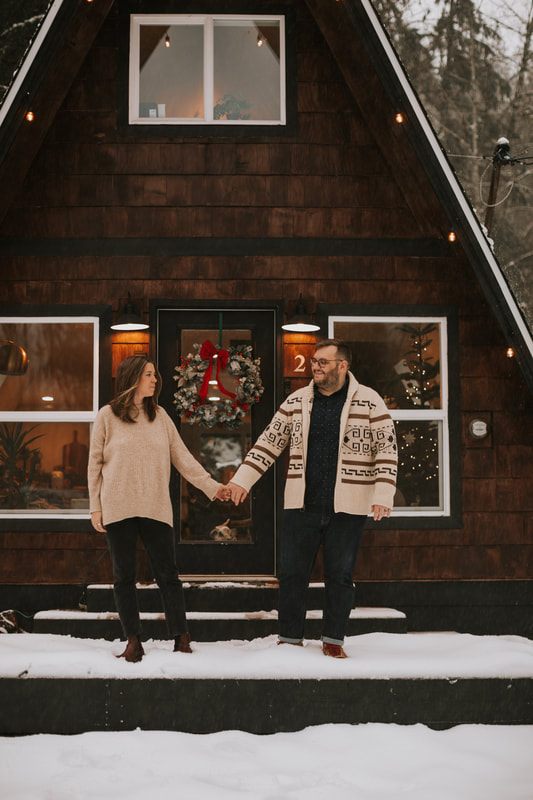 Family portrait of Ryan, Lyndsey, and their two dogs at the PNW cabin
