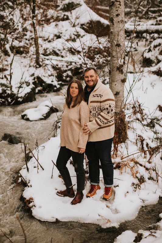 Family portrait of Ryan, Lyndsey, and their two dogs at the PNW cabin