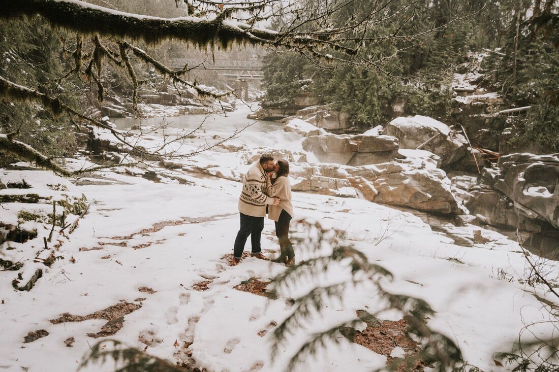 Close-up of the couple laughing together in the freshly fallen snow