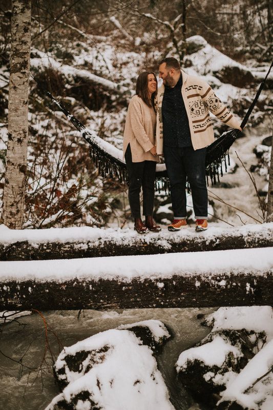 Ryan and Lyndsey walking hand in hand near the A-frame cabin
