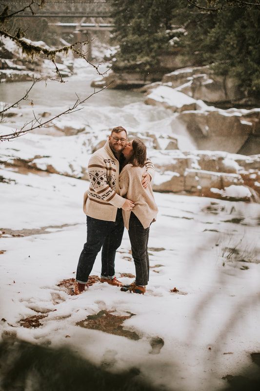 Ryan and Lyndsey embracing in the snow at That PNW Cabin in Index, WA