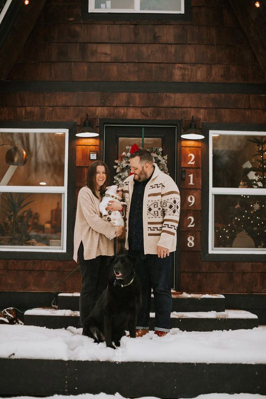 Close-up of the couple laughing together in the freshly fallen snow