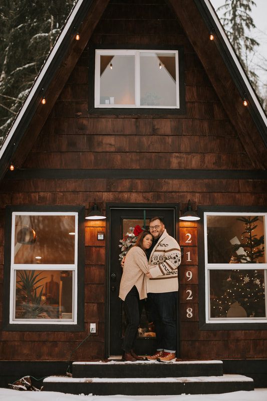 Ryan and Lyndsey walking hand in hand near the A-frame cabin