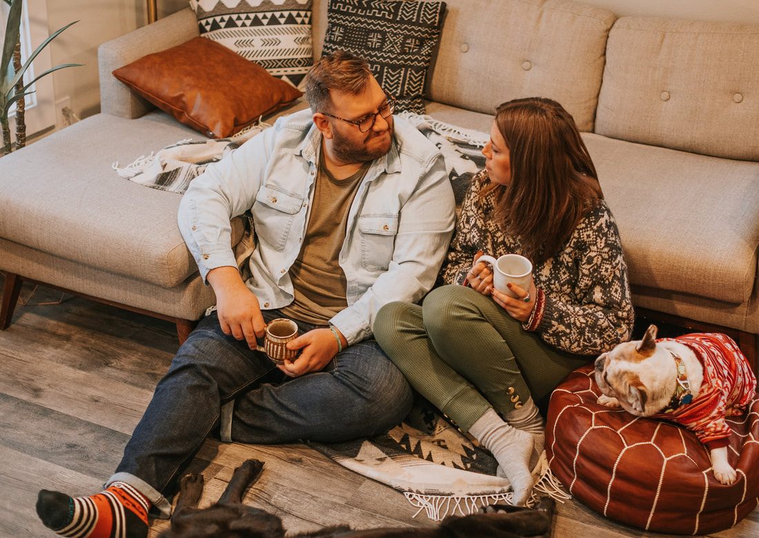 Candid moment between the couple and their dogs on the cabin porch