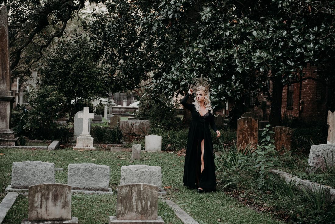 Silhouette among weathered cemetery statues in Charleston, South Carolina
