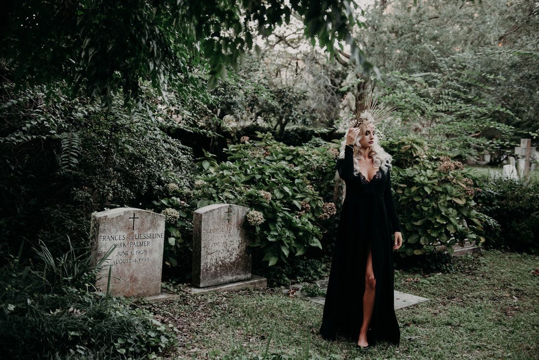 Silhouette among weathered cemetery statues in Charleston, South Carolina