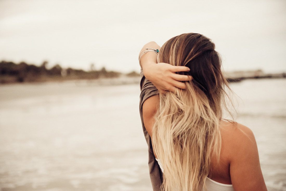 Two best friends posing together on Folly Beach, South Carolina